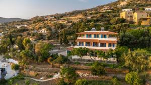 a house on a hill with houses on it at Agia Marina Apartments 5 Andros in Andros