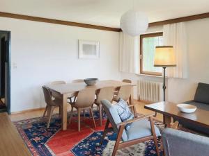 a living room with a dining room table and chairs at Haus Astrid in Kitzbühel