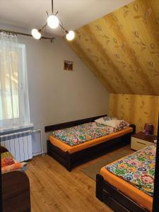 a bedroom with two beds in a attic at Dom na Zaciszu in Koniaków