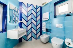 a blue bathroom with a toilet and a sink at Residenza Al Pesce D'Oro in Amalfi