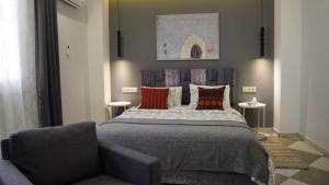 a bedroom with a bed and a chair at riad casa bahia asilah in Asilah