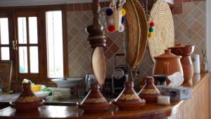 a kitchen counter with lots of vases on it at riad casa bahia asilah in Asilah