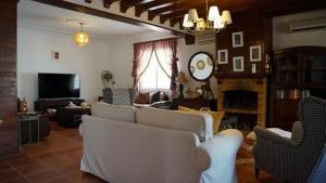 a living room with white furniture and a fireplace at riad casa bahia asilah in Asilah
