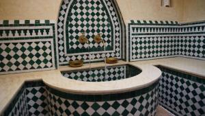 a bathroom with black and white checkered tiles at riad casa bahia asilah in Asilah