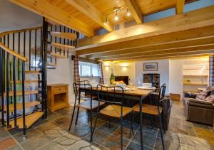 a living room with a table and a spiral staircase at Shicley in Trevine