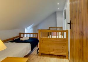 a bedroom with two twin beds and a staircase at Shicley in Trevine