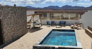 a swimming pool on the roof of a house at 4 FAMILY HOME WITH POOL, Fuerteventura-Gran Tarajal in Juan Gopar