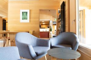 a living room with two chairs and a table at Naturfreunde Hostel Grindelwald in Grindelwald