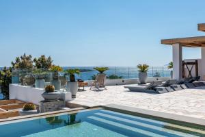 a swimming pool on the roof of a house at Villa Lilium I - Overlooking Psarou Bay, Mykonos in Psarou