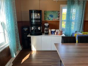 a kitchen with a table with a coffee maker on top at Auberge Lac-Saint-Jean in Roberval