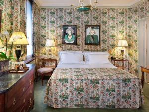 a bedroom with a bed and floral wallpaper at Hôtel Duc De St-Simon in Paris