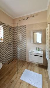 a bathroom with a shower and a sink and a mirror at Urban Haven in Subotica
