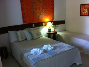 a bedroom with two beds with stuffed animals on it at Pousada Galeão Santa Anna in Barra Grande