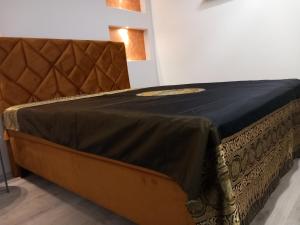 a bed in a room with a blue blanket on it at Apartman 101 in Sarajevo