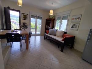 a living room with a couch and a table at Hillside house by the sea in Kokkino Nero