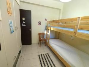 a room with two bunk beds and a hallway at Hillside house by the sea in Kokkino Nero