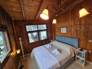 a bedroom with a bed in a wooden room at Athos SEAgull wagon in Ouranoupoli