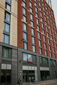 wysoki budynek z czerwonej cegły z mnóstwem okien w obiekcie Aparthotel Adagio Glasgow Central w Glasgow