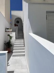 a staircase in a house with white walls at Summer Time in Ios Chora