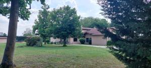 a house with a yard with two trees in front of it at Etesia in Feurs