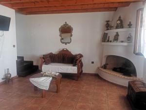 a living room with a bed and a fireplace at SeaL Villa in Alonnisos Old Town