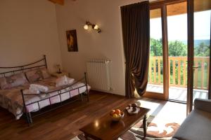 a bedroom with a bed and a sliding glass door at Agriturismo Gradec in Aurisina