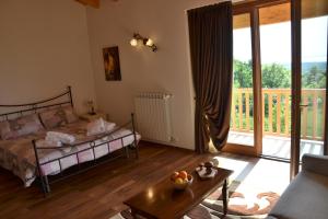 a bedroom with a bed and a sliding glass door at Agriturismo Gradec in Aurisina +27 photos