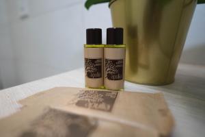 two bottles of essential oils sitting on a table at Arco Alto Rooms in Bari