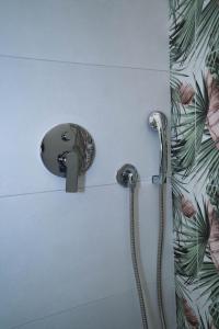 a shower in a bathroom with a shower head at Arco Alto Rooms in Bari