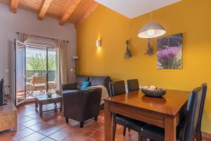 a dining room and living room with a table and chairs at Fuentes de la Hoz in Aguatón