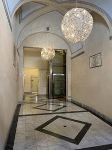 a hallway with two chandeliers in a building at La Suite di Chiara in Livorno