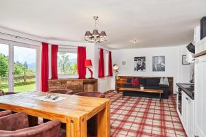 a living room with a table and a couch at Home suite home in Fieberbrunn