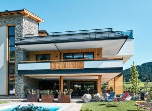 a house with a pool in front of it at Home suite home in Fieberbrunn