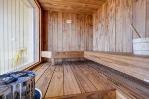 an empty sauna with wooden walls and wooden floors at Seaview Villa Resort in Kalajoki