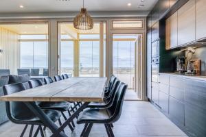 a dining room with a wooden table and chairs at Seaview Villa Resort in Kalajoki