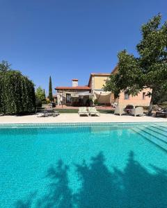 a swimming pool in front of a house at Espacio Shangrila.One in Uceda