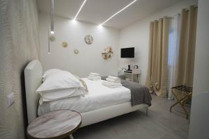 Postel nebo postele na pokoji v ubytování Arco Alto Rooms