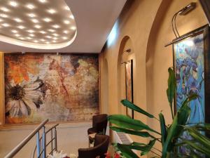 a lobby with a large painting on the wall at Семеен Хотел "Булаир" in Burgas