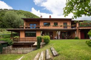 a large house with a balcony on a yard at L'Adó in Ripoll