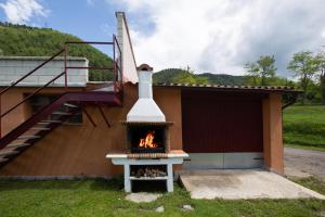 a fireplace outside of a house with a staircase at L'Adó in Ripoll