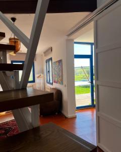 een woonkamer met een bank en een groot raam bij Espacio Shangrila.One in Uceda