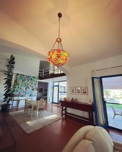 a living room with a table and a chandelier at Espacio Shangrila.One in Uceda