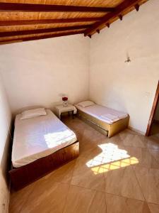 a room with two beds and a table in it at Condominio Portal del Sol, Cabaña en la Mesa de los Santos in Los Santos +14 photos