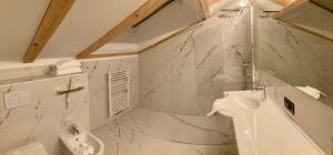 a white bathroom with a sink and a toilet at Residence Emmy in San Candido +58 photos