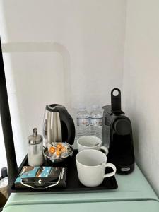 a counter with a coffee maker and cups on it at Ministerium underground studio in Thessaloniki