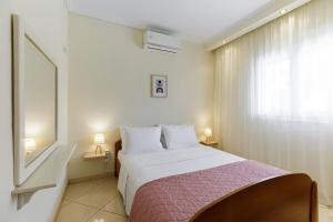 a bedroom with a bed and a large window at Villa Fabiola in Vergia