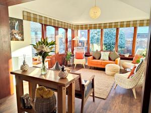 a living room with a table and chairs at Yewtree House in Penrith