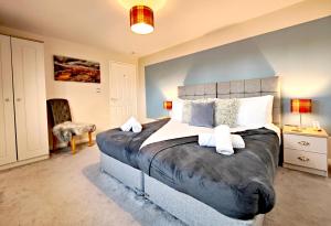 a bedroom with a large bed in a room at Yewtree House in Penrith