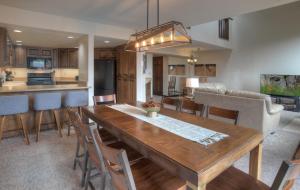 a kitchen and dining room with a wooden table and chairs at Cascade Village 50 Near Purgatory - Marmot Meadows Retreat in Durango Mountain Resort