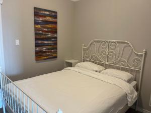 a bed in a bedroom with a painting on the wall at Auberge Lac St-Jean Phase 2 in Roberval